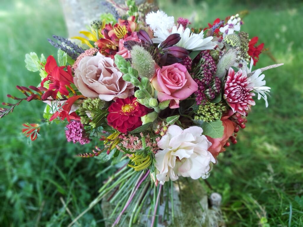 A vibrant bouquet of summer flowers in a loose wildflower style by Camomile and Cornflowers.