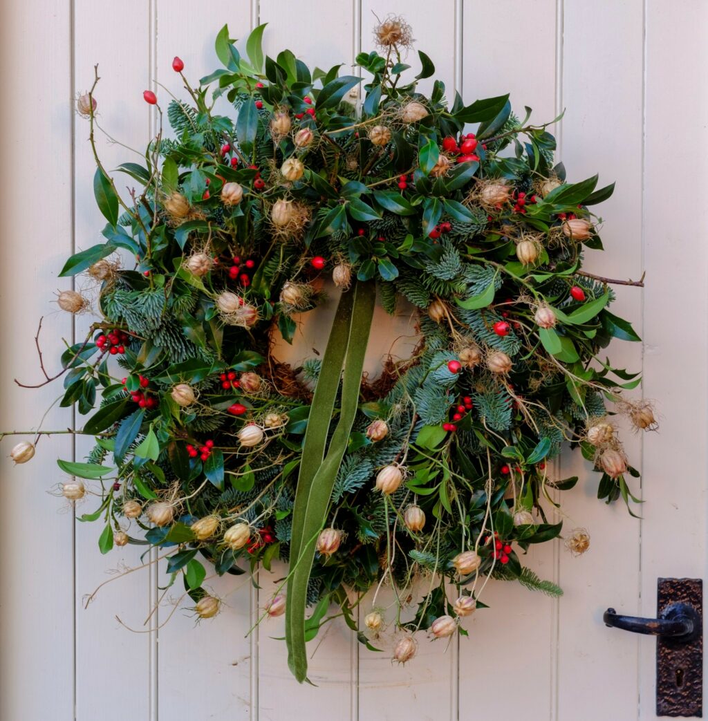 A traditional fresh evergreen wreath made with British grown foliage, berries and nigella seedbeds. Fierce Blooms, Cheshire.