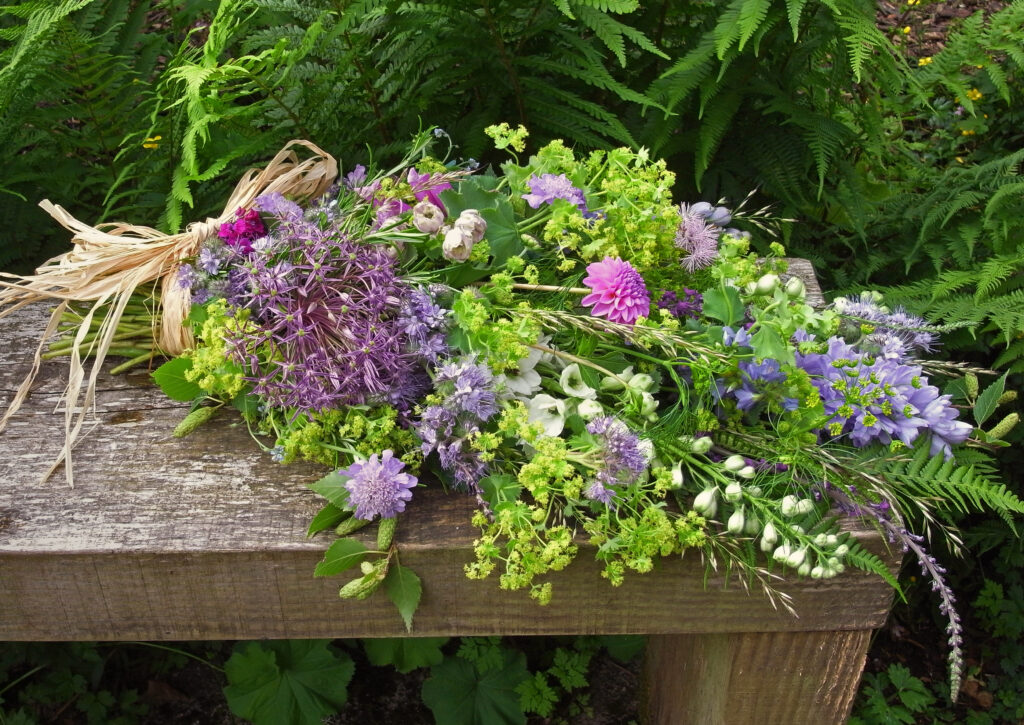 A natural tied funeral sheaf of early summer flowers by Galloway Flowers