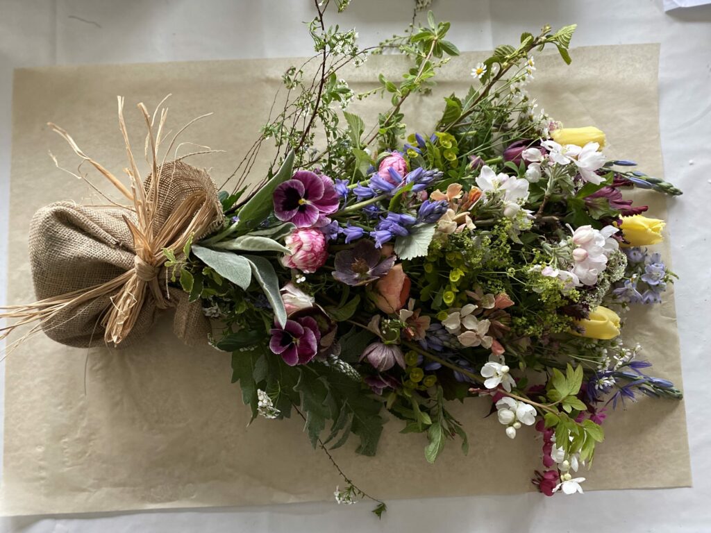 A natural spring funeral sheaf with British cut flowers by Henthorn Farm Flowers