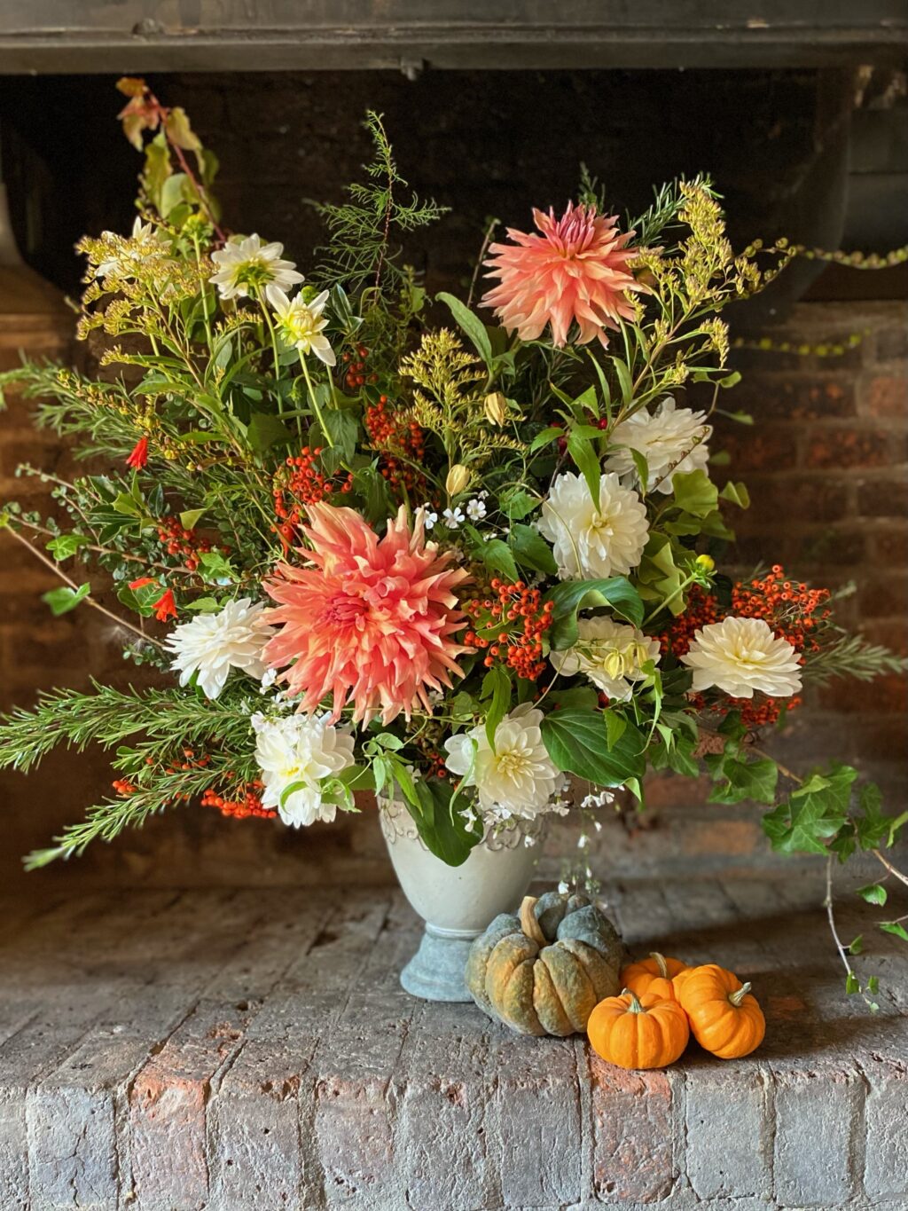 An autumn vase arrangement with mini pumpkins