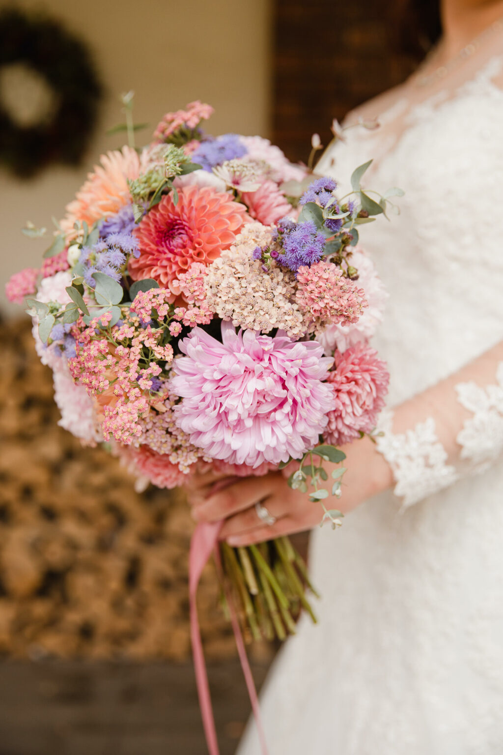 A pastel textured wedding bouquet with dahlias and pale pink chyrsanths by Nature's Posy. Photo credit: Michelle Hugglestone