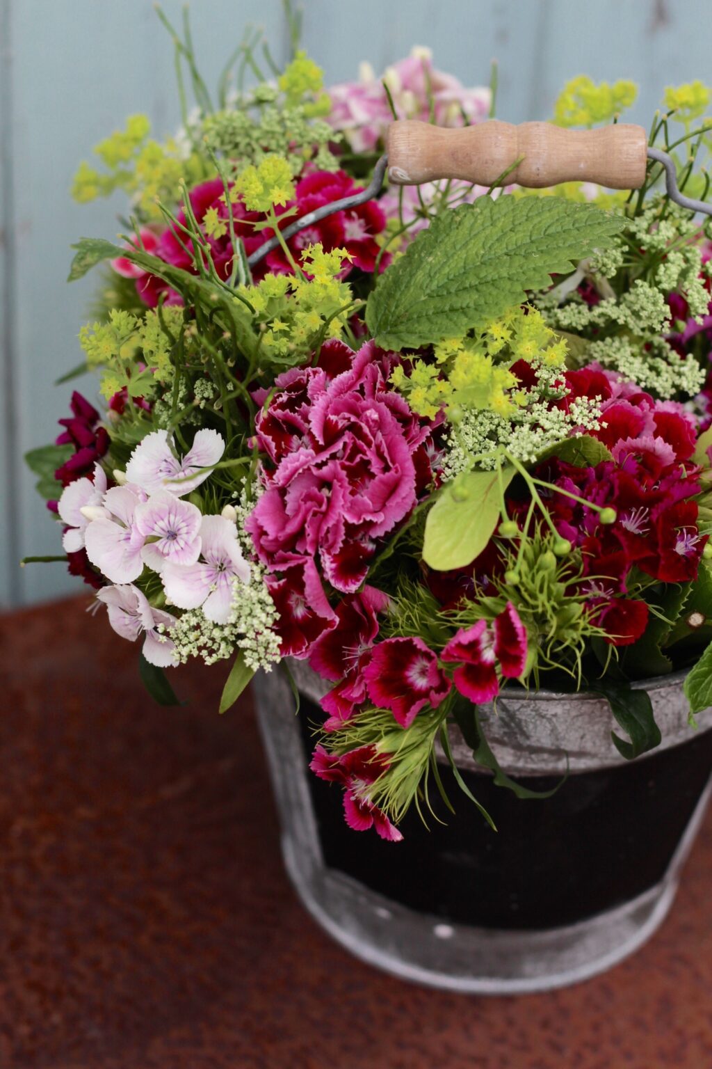 These posies of scented sweet william in a range of rich pinks, are brightened with the vivid greens of lady's mantle and delicously perfumed lemon balm leaf. Photo: Tuckshop Flowers