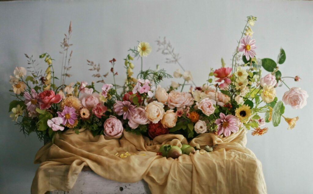 Wildbunch arranges abundant garden roses in a generously scented long low style arrangement for a wedding table