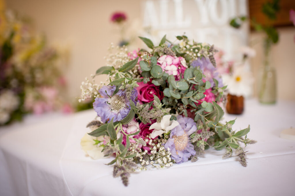 Woodchurch Cottage Flowers adds mint to a pastel early summer bride's bouquet with blue scabious and pinks