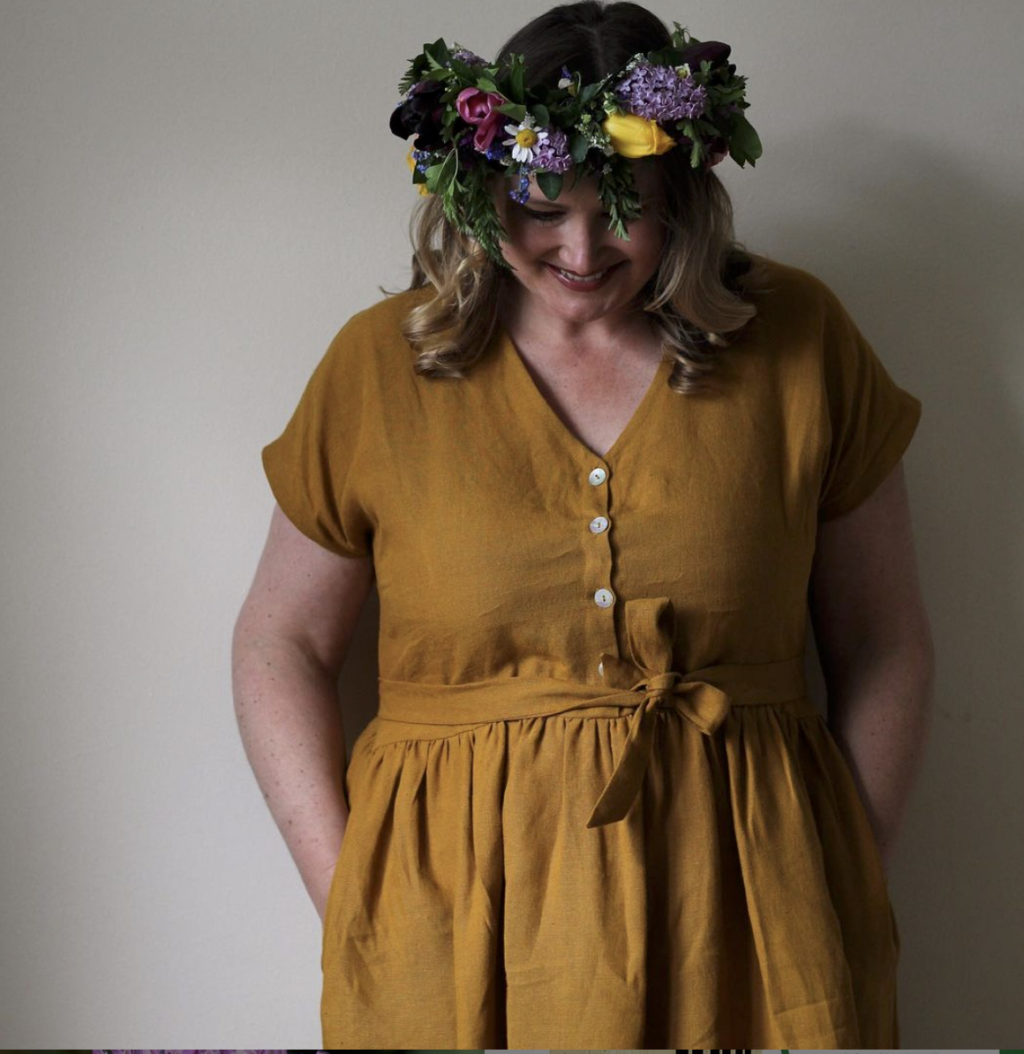 Lauren of the Fox and Dingo models a spring flower crown to complement the rich ochre of her dress