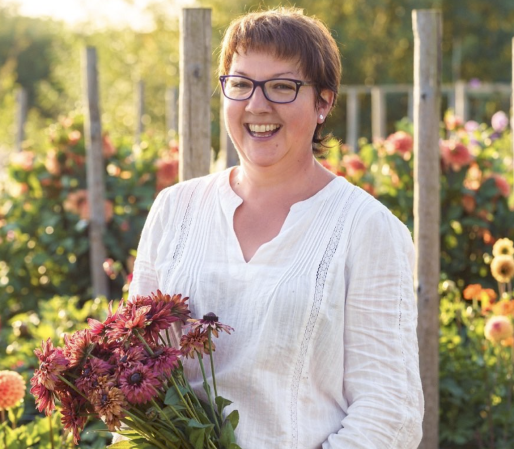 Emma of The Fellside Flower Company holds a bunch of freshly cut rudbeckia grown on her flower farm.